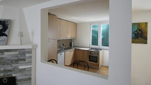 a small kitchen with a sink and a stove at Italianway - Riva Soldino 9 in Laglio