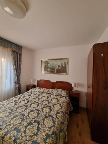 a bedroom with a bed and a painting on the wall at Albergo Casa Peron in Venice