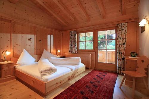 a bedroom with a bed in a wooden room at Appartement Riedl Martin in Brixen im Thale