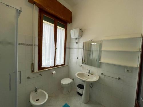 a bathroom with a toilet and a sink at A due passi dal Mare in Castiglione della Pescaia