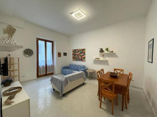 a living room with a couch and a table at A due passi dal Mare in Castiglione della Pescaia
