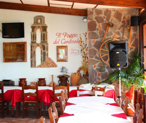 a dining room with tables and a tv on the wall at Villa delle Muse da Imma in Palinuro