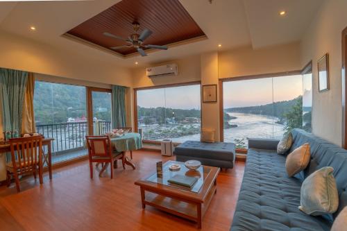 a living room with a couch and a table at Divine Resort & Spa in Rishīkesh