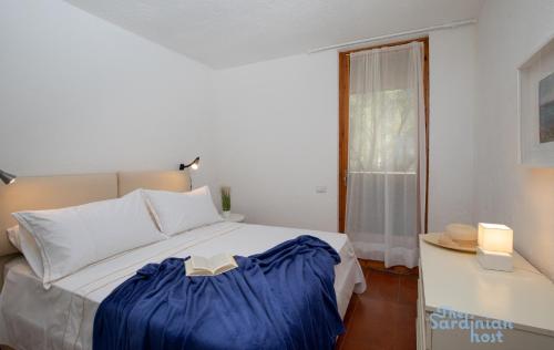 - une chambre avec un lit doté d'une couverture bleue dans l'établissement Iole's House, finestra sul mare, à Olbia