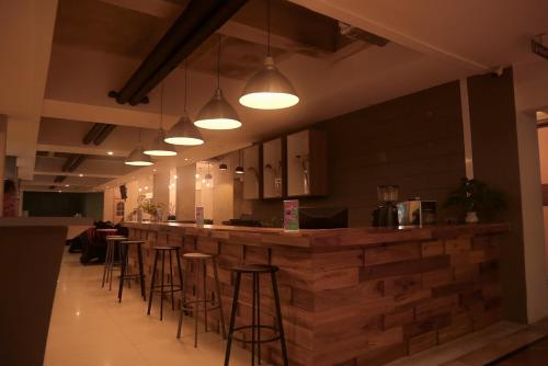 a bar in a restaurant with bar stools at The Hills Batam in Nagoya
