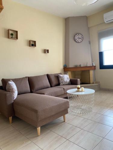 a living room with a couch and a table at Rozos House in Loutsa