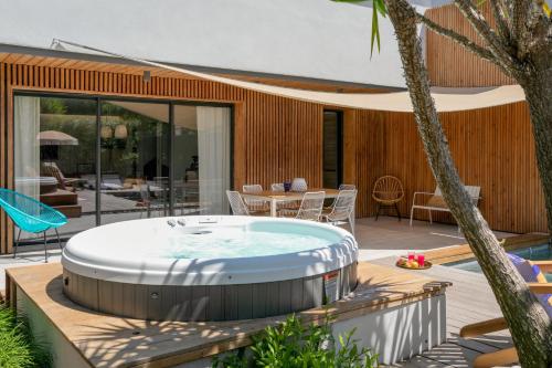 a hot tub on the deck of a house at Villas les Capucines in Sète
