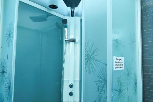 a glass shower door with a sign on it at Arctic SnowHotel & Glass Igloos in Sinettä