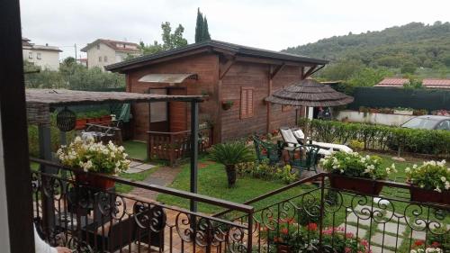 a balcony view of a garden with a house at Chalet Impero in Scauri