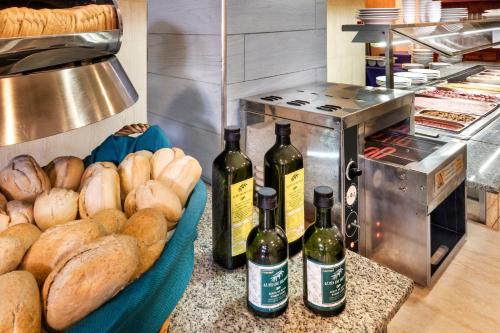 a bunch of bread and bottles of wine on a counter at Hotel Andalucía in Benidorm