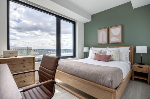 a bedroom with a bed and a large window at Seaport 1BR w Gym Pool WD Doorman BOS-280 in Boston