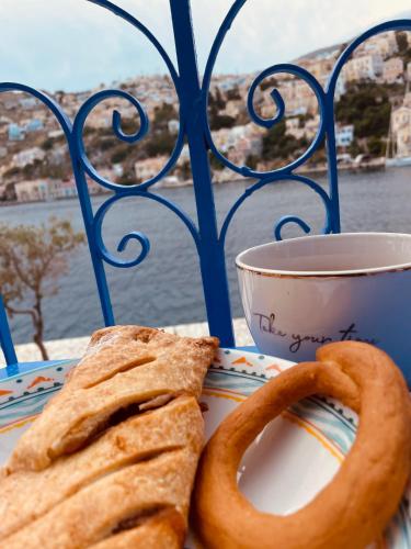 a plate with bread and a cup of coffee at Cavo apartment in Symi