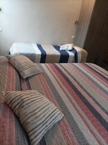 two beds with pillows on them in a room at B&B Perbaccobar in Ono San Pietro