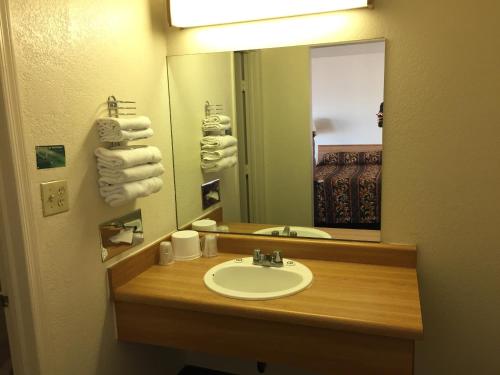 a bathroom with a sink and a mirror at EZ 8 Motel Airporter in Phoenix
