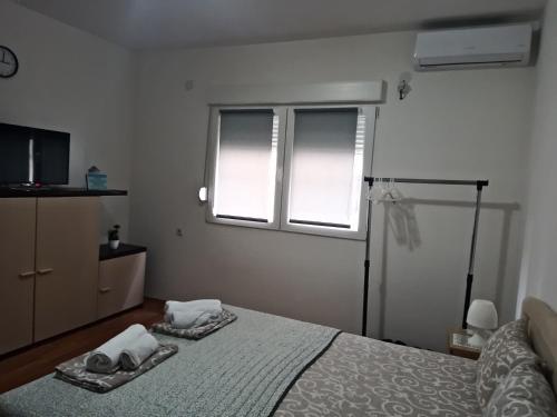 Ένα ή περισσότερα κρεβάτια σε δωμάτιο στο Relax Apartmani Niš