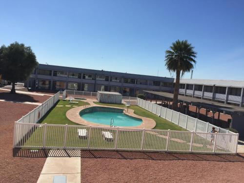 a building with a swimming pool in front of a building at EZ 8 Motel Airporter in Phoenix