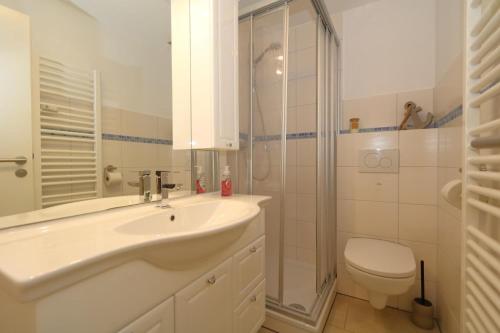 a bathroom with a sink and a shower and a toilet at Fischer in Westerland