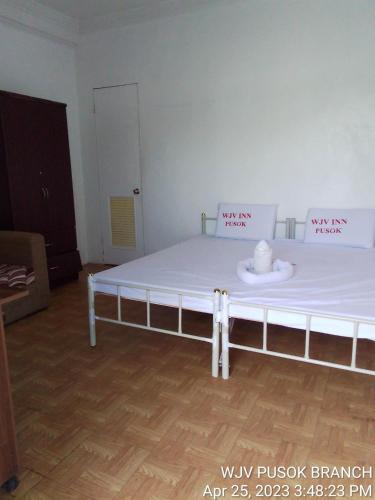 a bed in a room with a white mattress at WJV INN PUSOK in Pajo