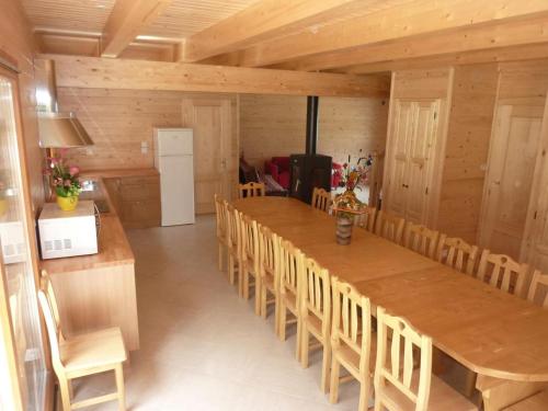 a large dining room with a long table and chairs at Chalet Bellevue in Les Orres