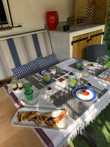 a white table with plates of food on it at LOU PANTAI in Levens