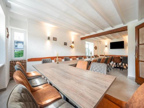 a conference room with a large wooden table and chairs at Eifel Nationalpark Grand Lodge in Schleiden