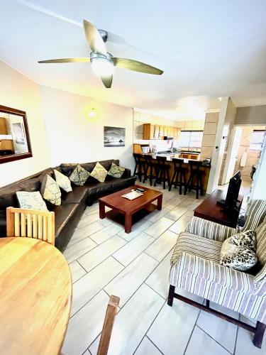 a living room with a couch and a table at Perna Perna Lodge St Lucia in St Lucia