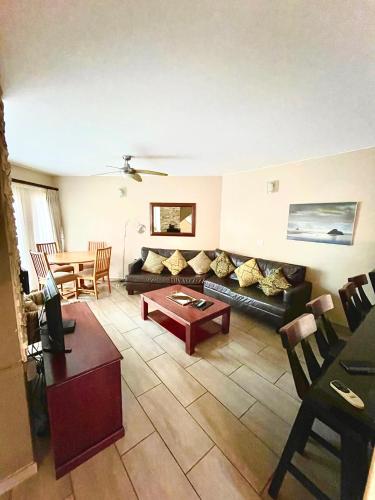 a living room with a couch and a table at Perna Perna Lodge St Lucia in St Lucia