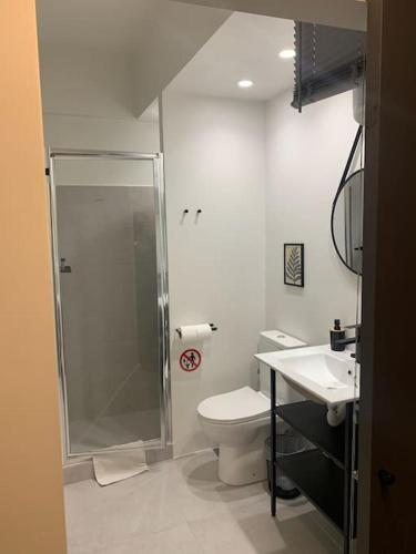 a bathroom with a shower and a toilet and a sink at E2G URBAN STAY with Balcony in Thessaloniki