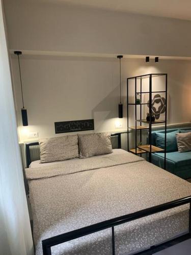 a bedroom with a large bed and a couch at E2G URBAN STAY with Balcony in Thessaloniki