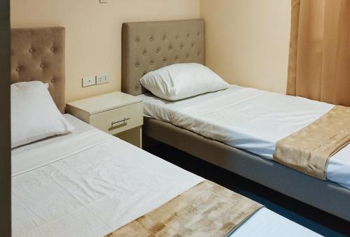 two beds in a small room with two bedsvisor at RedDoorz @ Benelio Suites Pavia Iloilo in Pavia