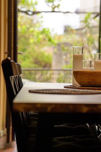 a table with a bowl on it and a window at Les Lauriers Roses - Maison d'Hôtes in Barjac