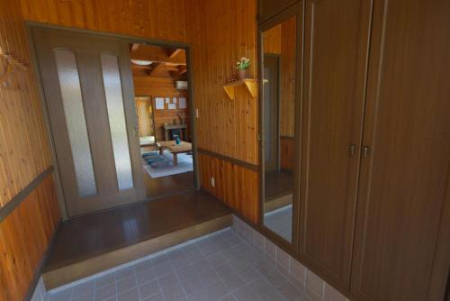 a hallway of a house with wooden walls at ocean resort mint オーシャンビューを満喫!かわいい三角屋根の三階建て貸切別荘 in Shioura