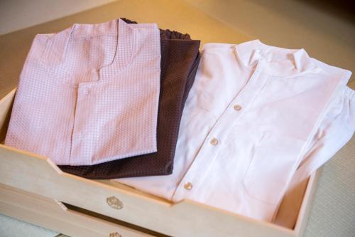 two shirts sitting in a wooden box at Suiun in Hakone