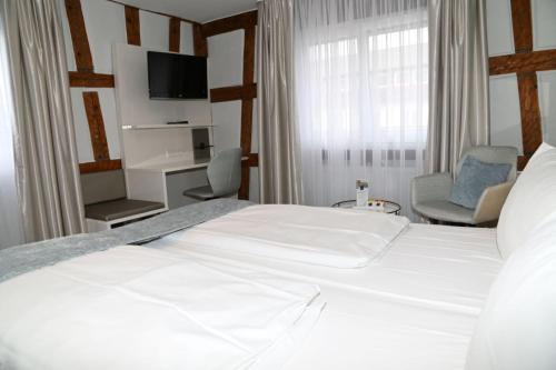 Ένα ή περισσότερα κρεβάτια σε δωμάτιο στο Hotel Hoeri am Bodensee