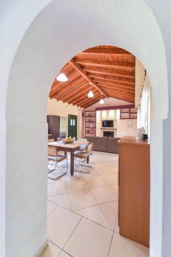 a kitchen and dining room with an archway in a house at EMA Spa The Red house in Potámion