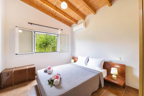 a bedroom with a bed and a window at EMA Red house in Potámion