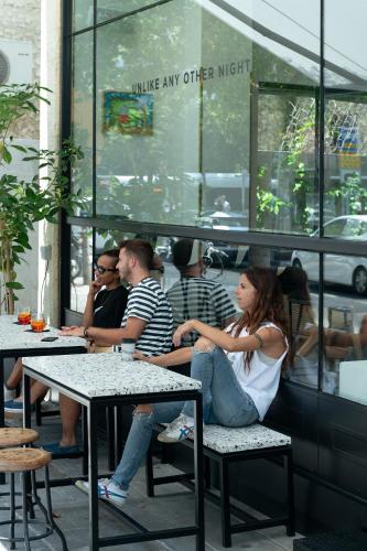 a group of people sitting at tables in a restaurant at ISLA Tel Aviv in Tel Aviv