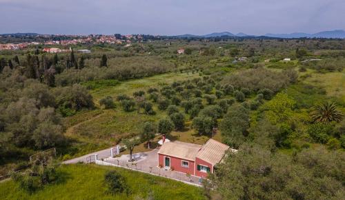 an aerial view of a house in a field at EMA Spa The Red house in Potámion