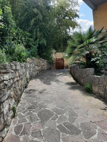 a stone walkway next to a stone wall at Adri's House in Monterotondo