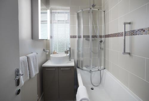 a bathroom with a sink and a glass shower at Stella in Marcross