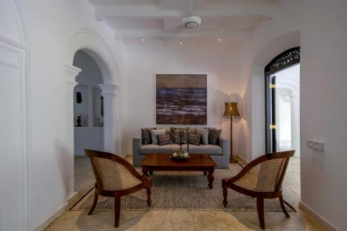 a living room with a couch and two chairs at The Well House Galle Sri Lanka in Unawatuna