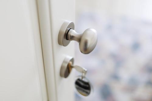 a door knob with a key at Hotel Central - Baile Olanesti in Băile Olăneşti