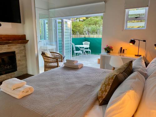 a bedroom with a bed with two towels on it at Vida Nova Retreat in Cape Town