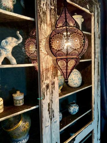 a chandelier in a cabinet filled with pottery at Ca’Bosello Ristorante e locanda in Deserto