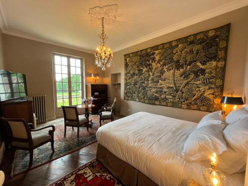 a bedroom with a large tapestry on the wall at Charnay Plaisance, piscine, les chambres du chocolatier Daniel Mercier in Vierzon