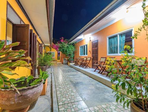 a courtyard of a building with benches and plants at MANDARIN LODGE by victor in Hua Hin