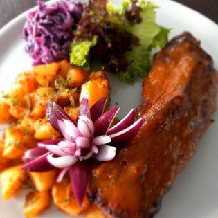 a white plate of food with meat and vegetables at Hotel i Restauracja 13 Smaków in Częstochowa