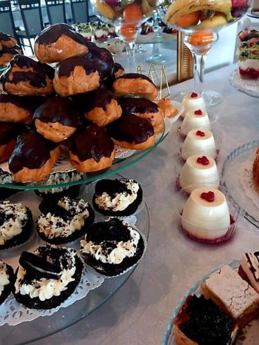 a table topped with trays of pastries and desserts at Hotel i Restauracja 13 Smaków in Częstochowa
