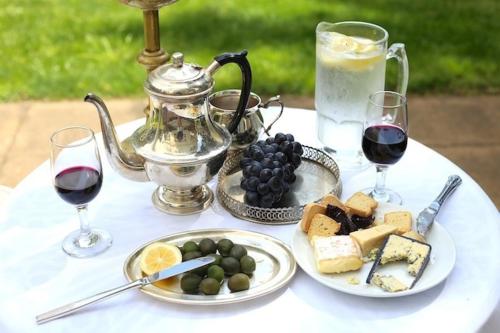 a table with plates of food and glasses of wine at The Robertson Hotel in Robertson