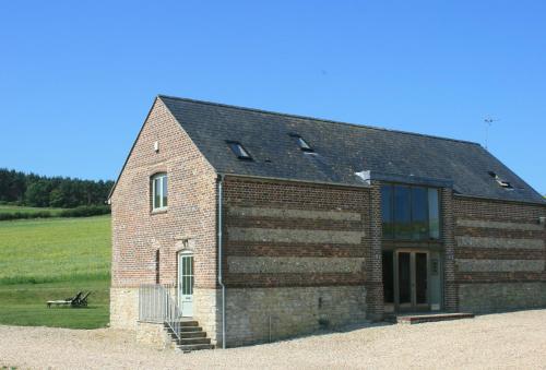 a brick building with a window on the side of it at Blagdon Lower Barn in Winterborne Steepleton